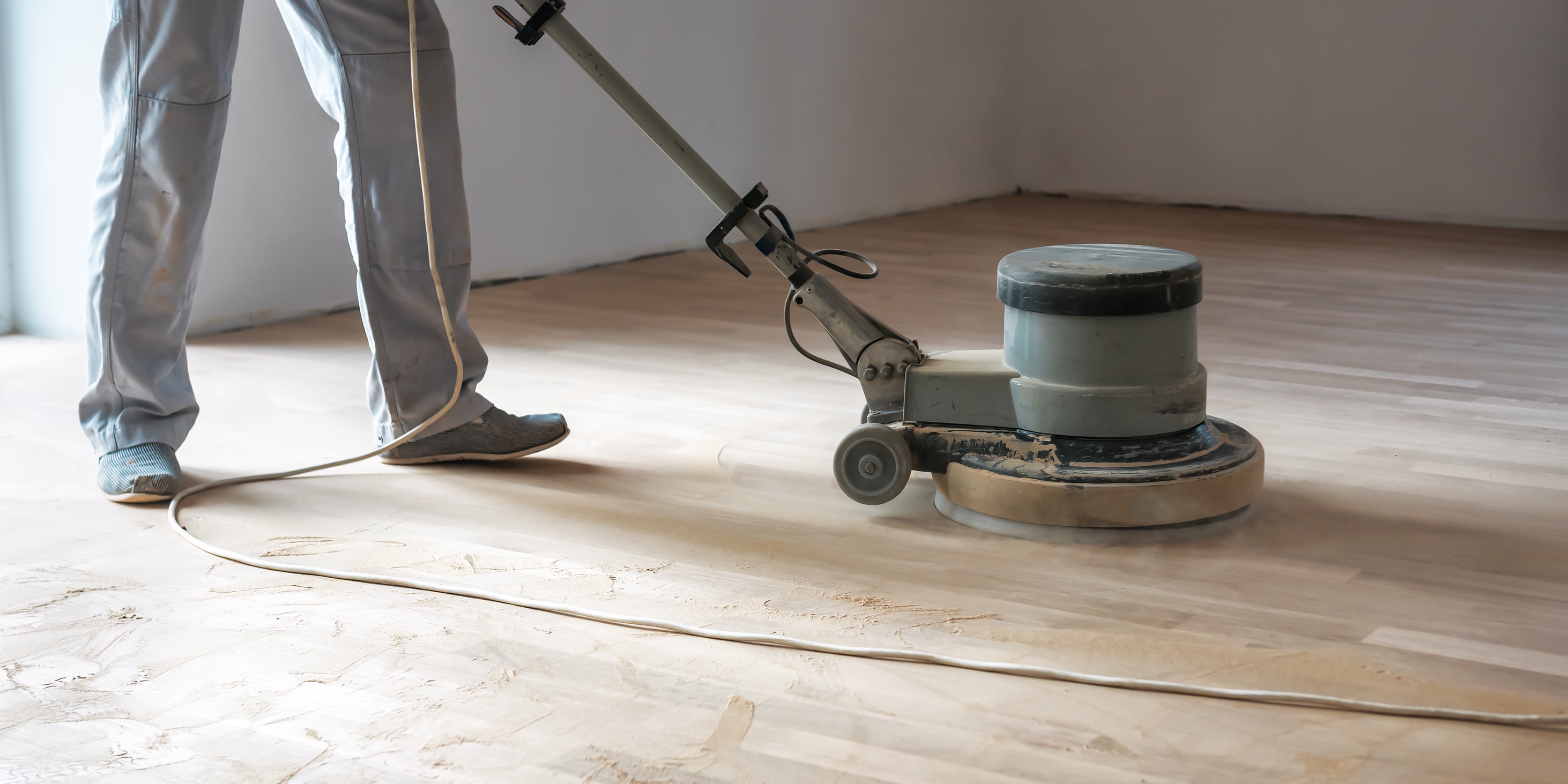 Sanding wood floor during the refinishing process