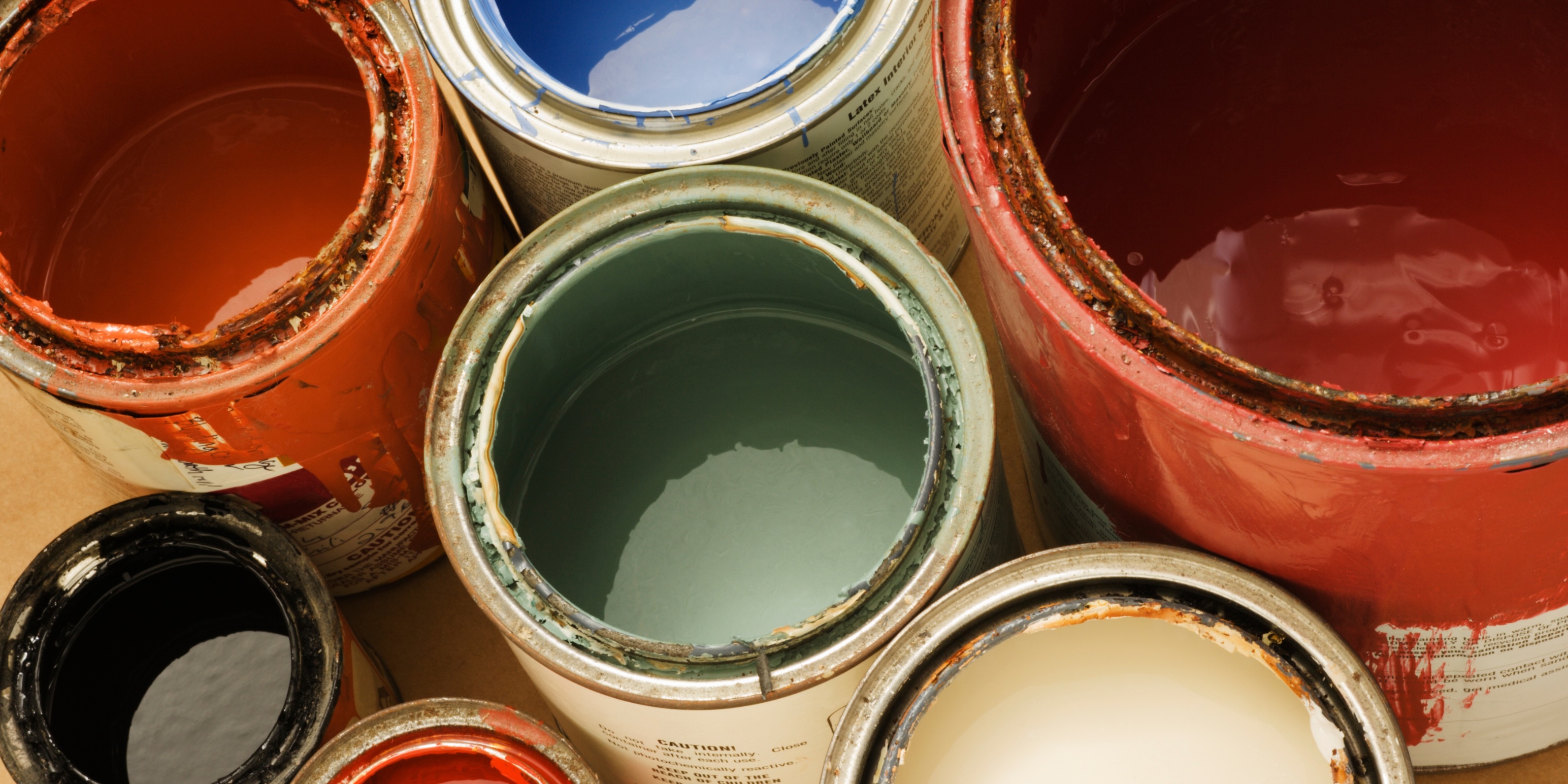 Cans of conventional paints containing harmful chemicals